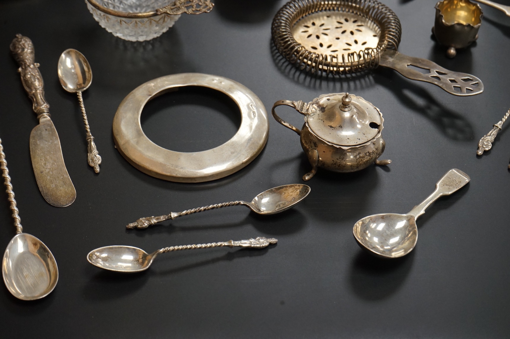 A George V six piece silver condiment set by Mappin & Webb, Birmingham, 1925, two George V silver mounted photograph frames, a small pair of late Victorian silver salts, a silver mounted cut glass dish, a set of six silv